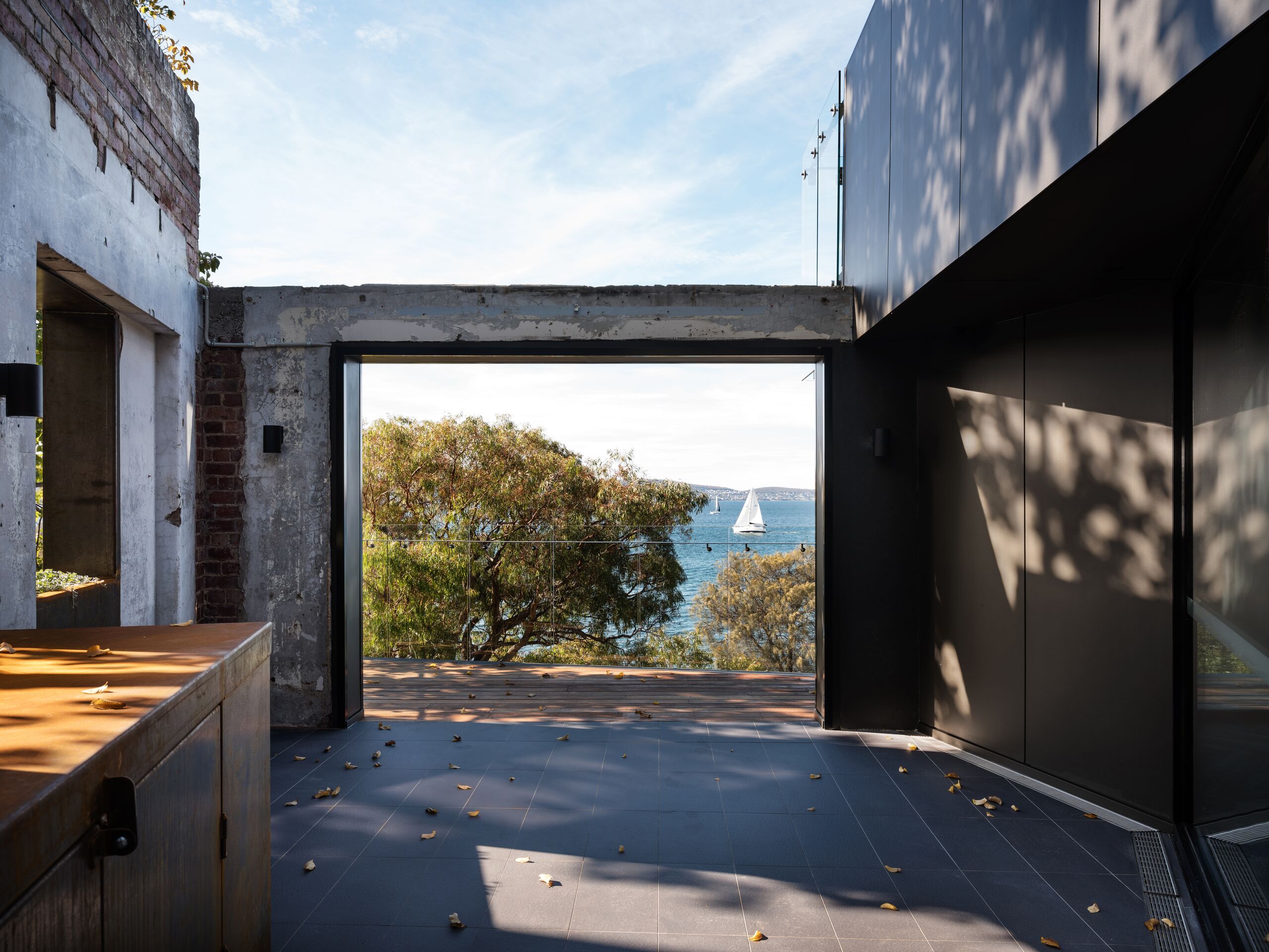 Concrete-framed opening in the original wall looking out to the Derwent River