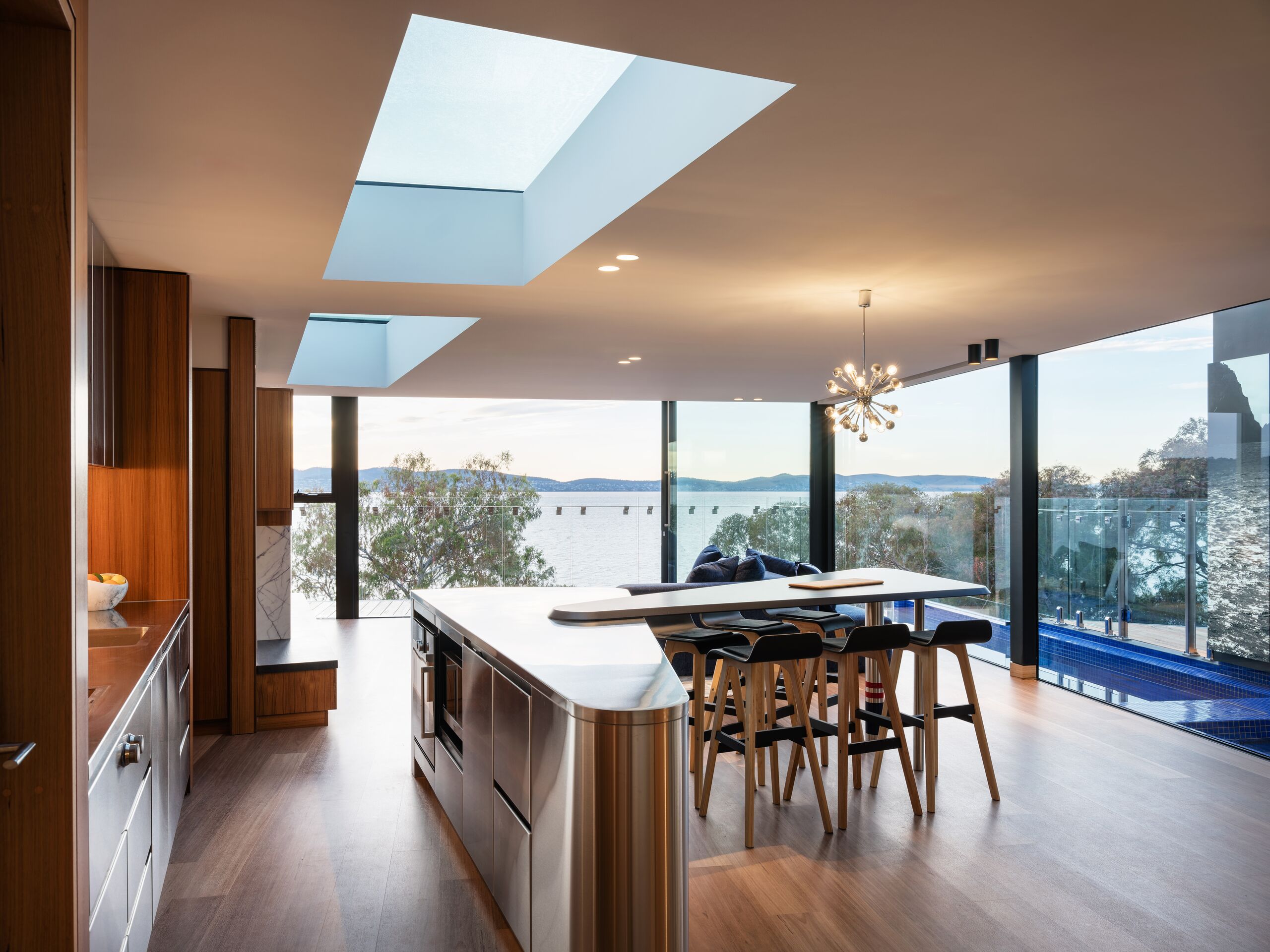 Open-plan kitchen and dining with skylights and river views